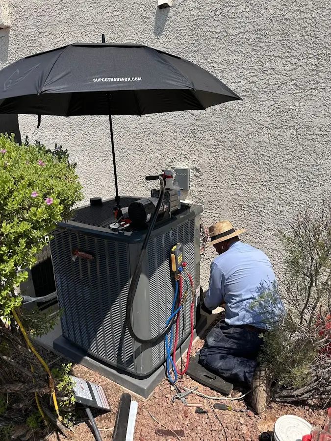 HVAC technician performing outdoor AC maintenance in Pittsburg